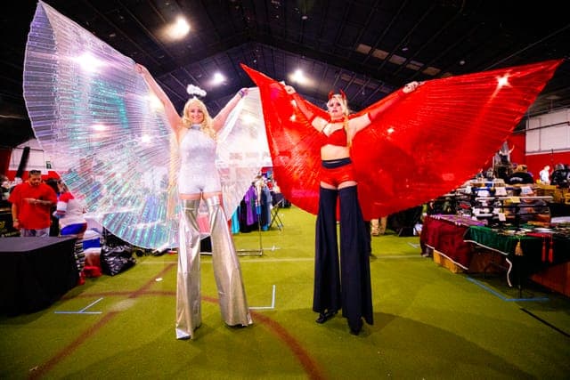 Winged performer lights the floor
